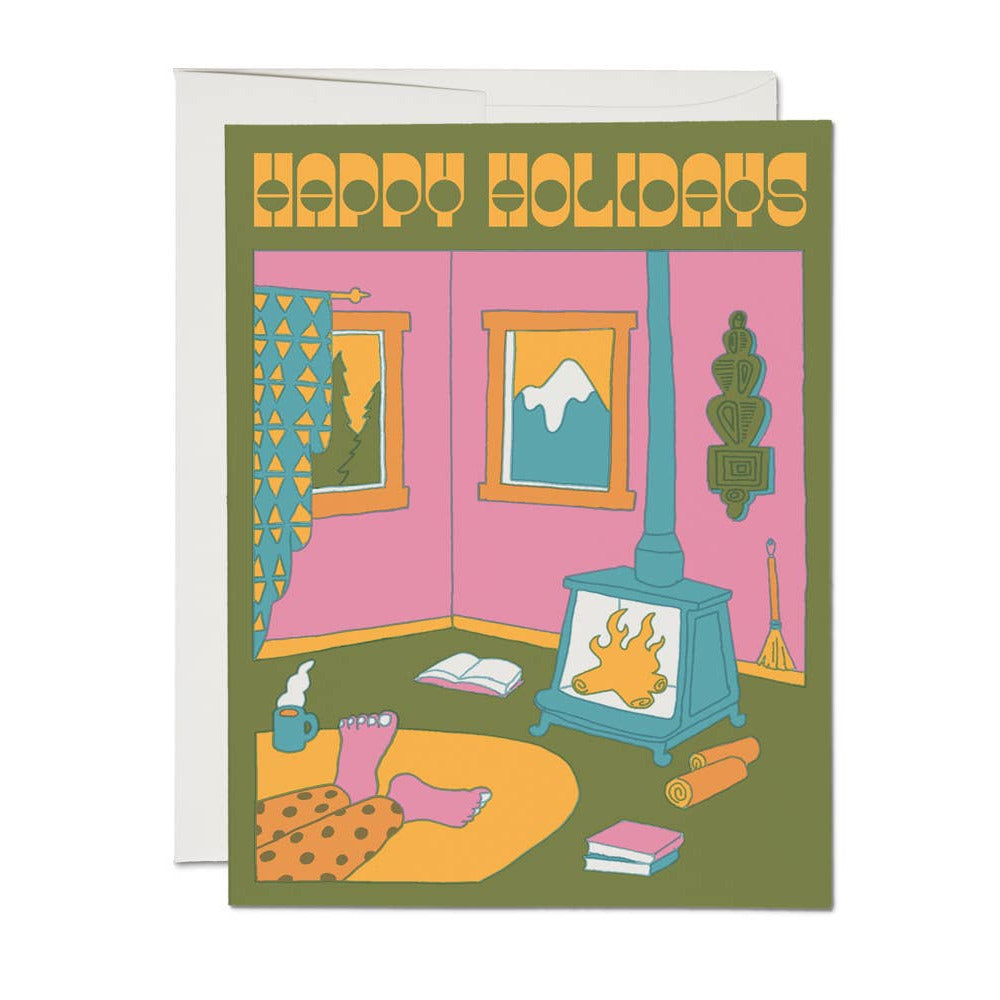 Greeting card with a festive scene of a living room and 'Happy Holidays' text.