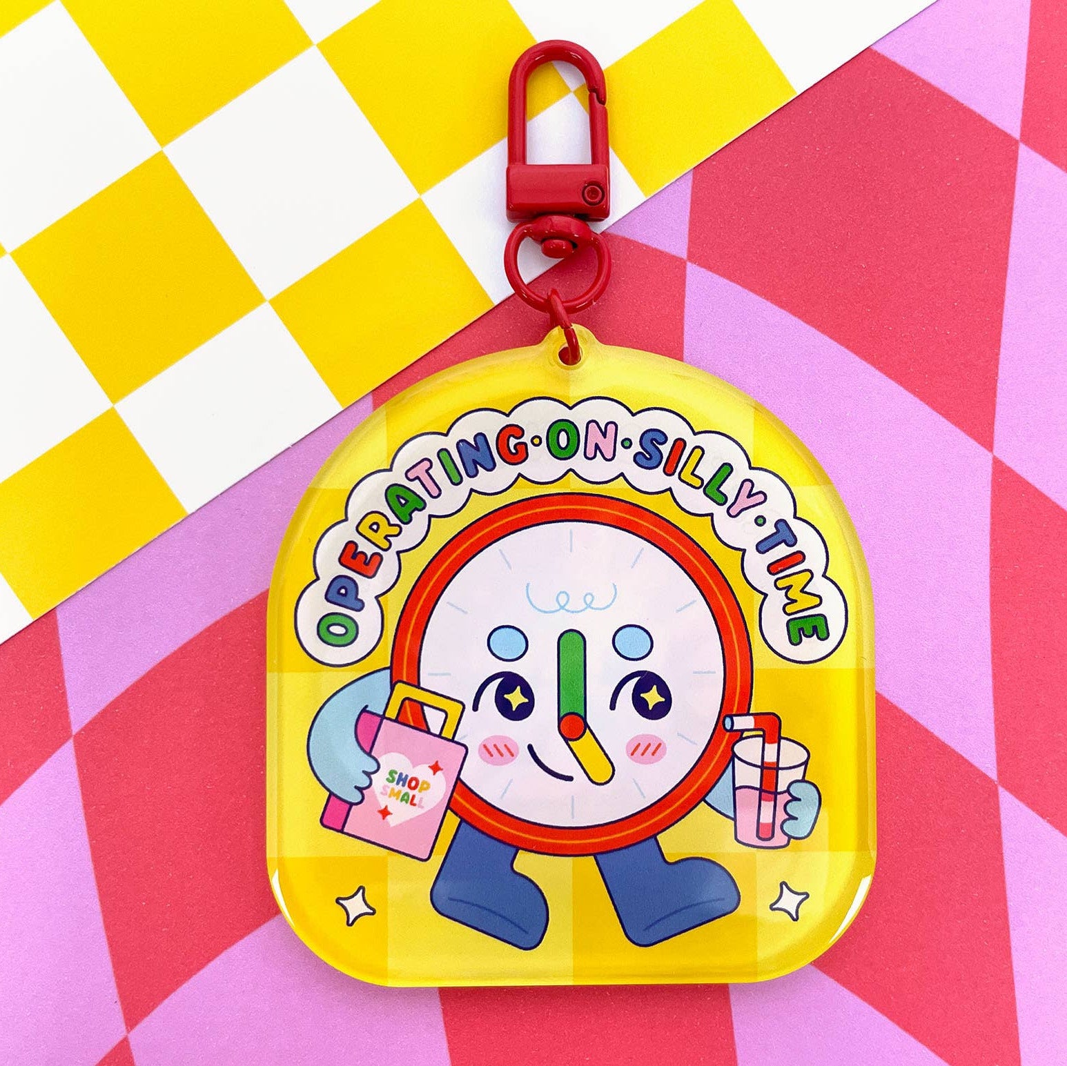 Colorful keychain with cartoon character on a checkered background
