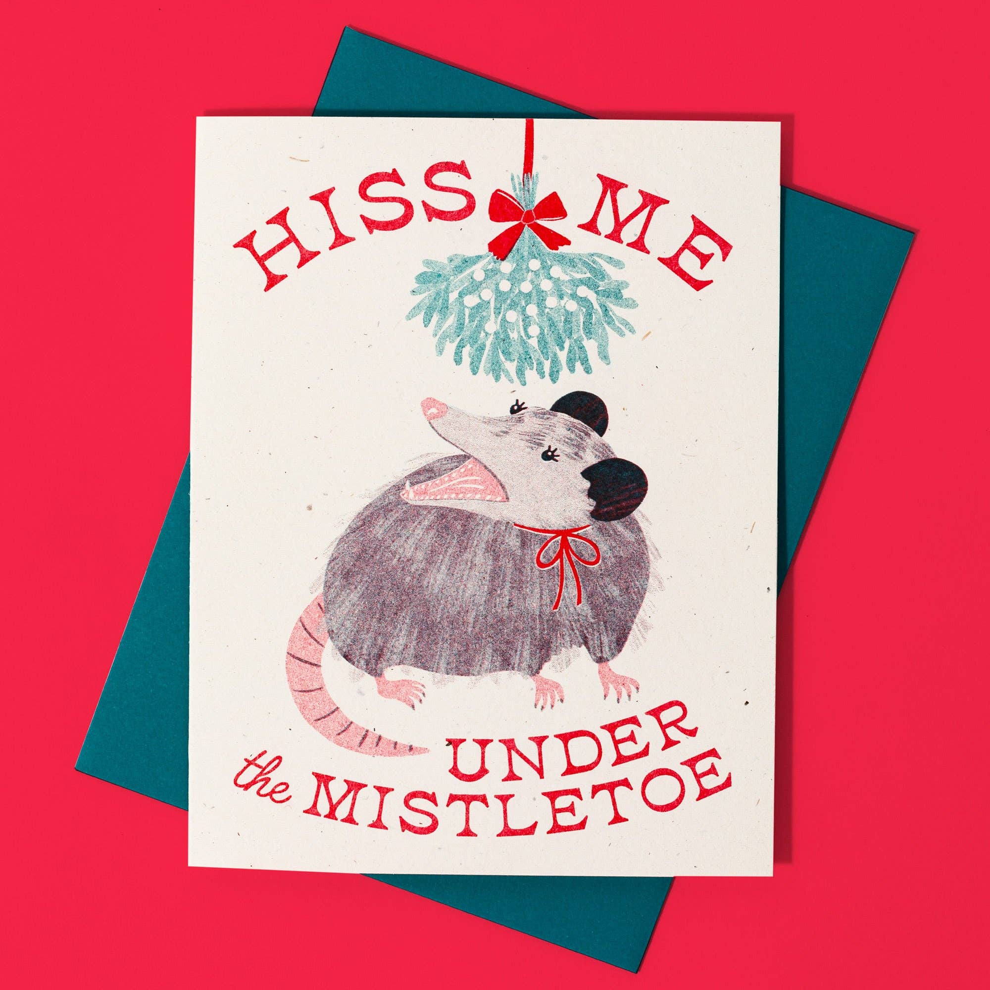 Card with a opossum illustration and text 'Hiss me under the mistletoe' on a red background