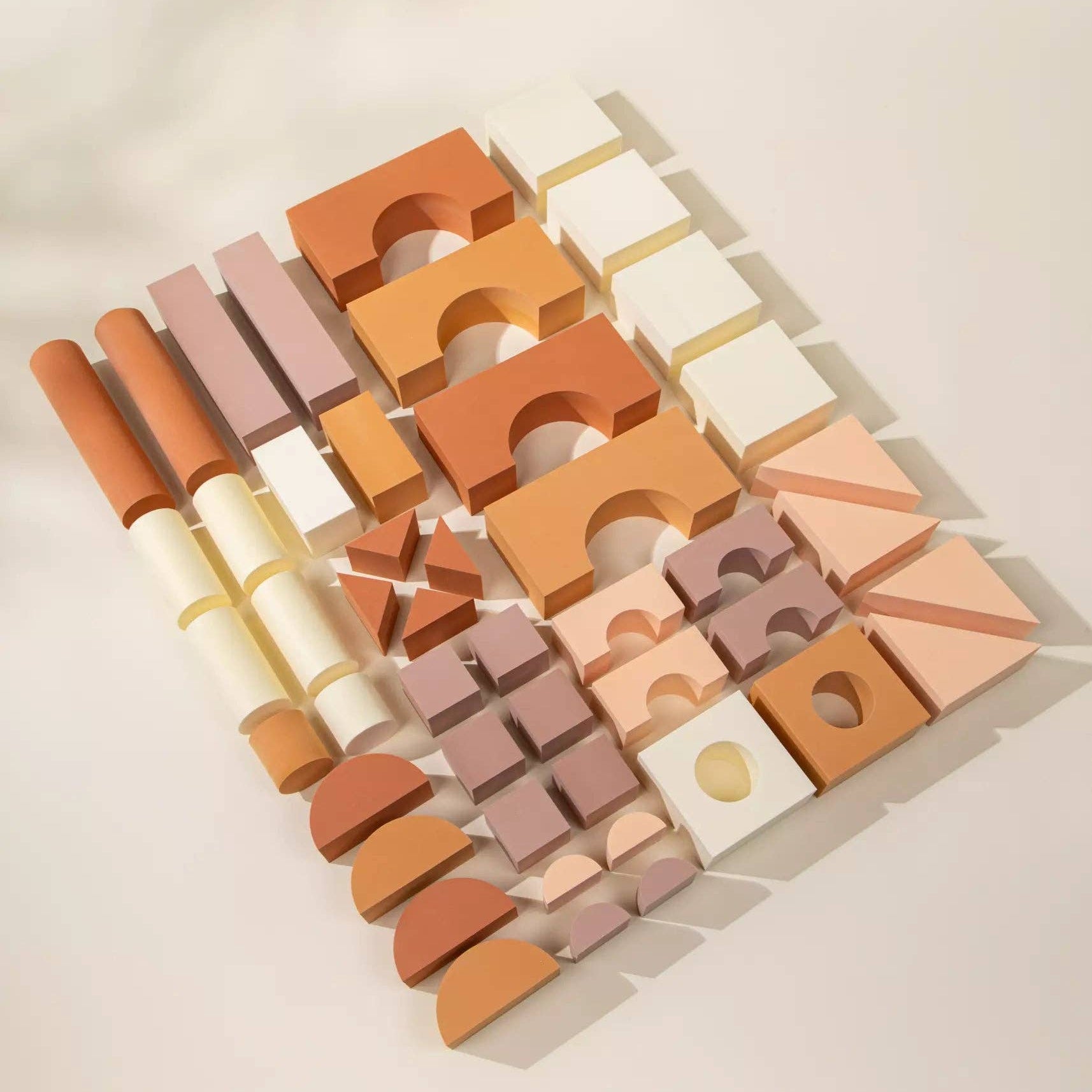Set of colorful geometric wooden blocks on a light background
