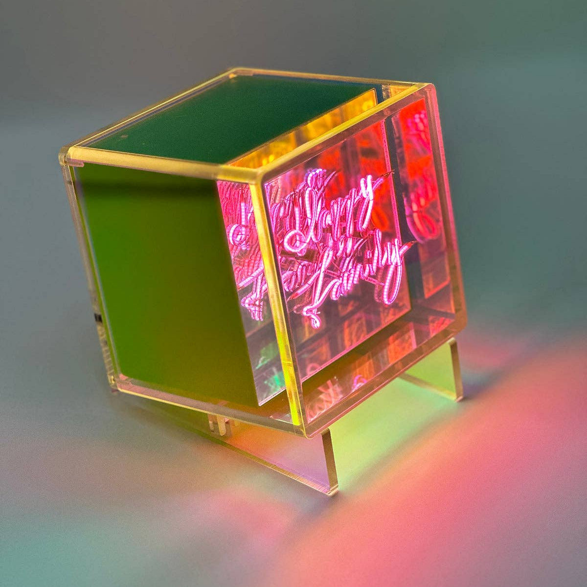 Neon cube with colorful design on a gradient background