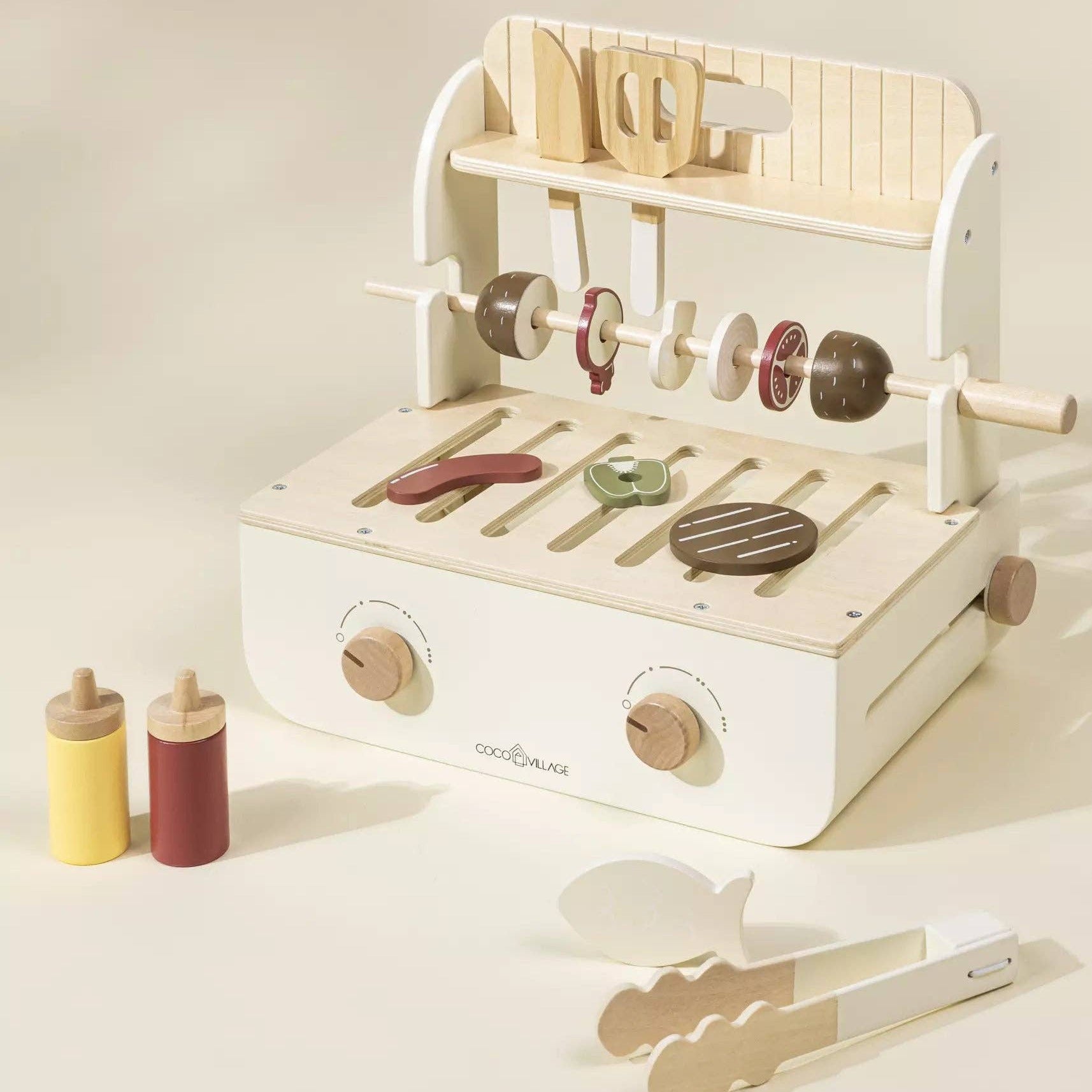 Wooden toy grill set with accessories on a light background