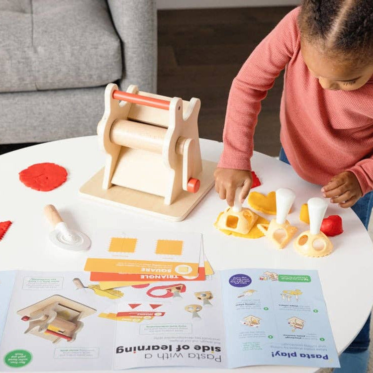 Child playing with a wooden toy set on a table