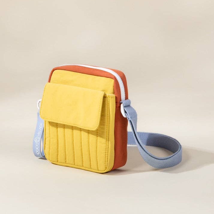 Multicolored quilted crossbody bag on a beige background