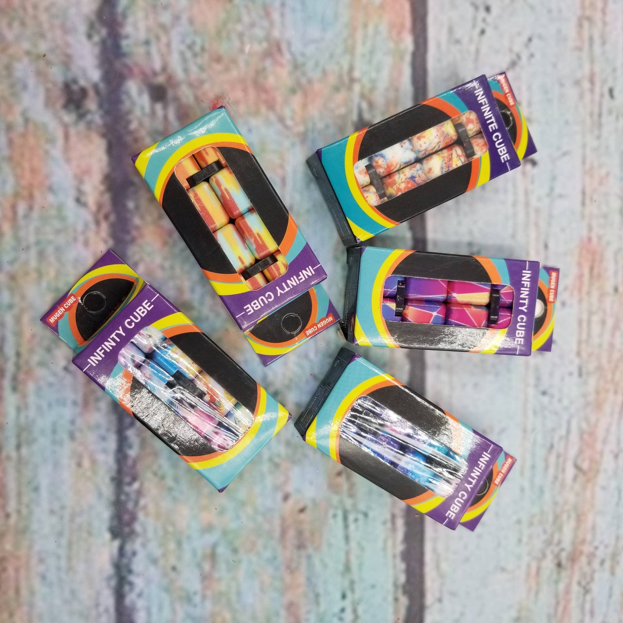 Five packages of 'Infini' products on a textured surface