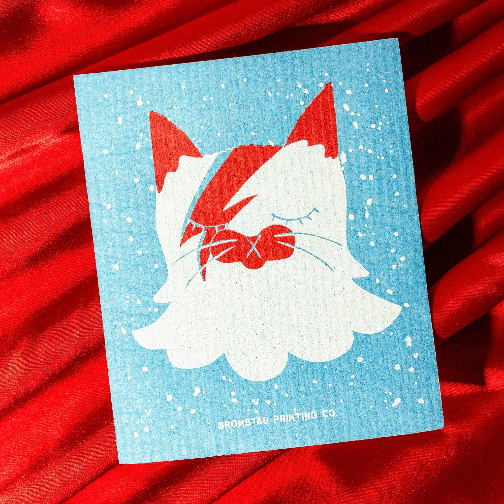sponge with a cat wearing a Bowie face design on a red background