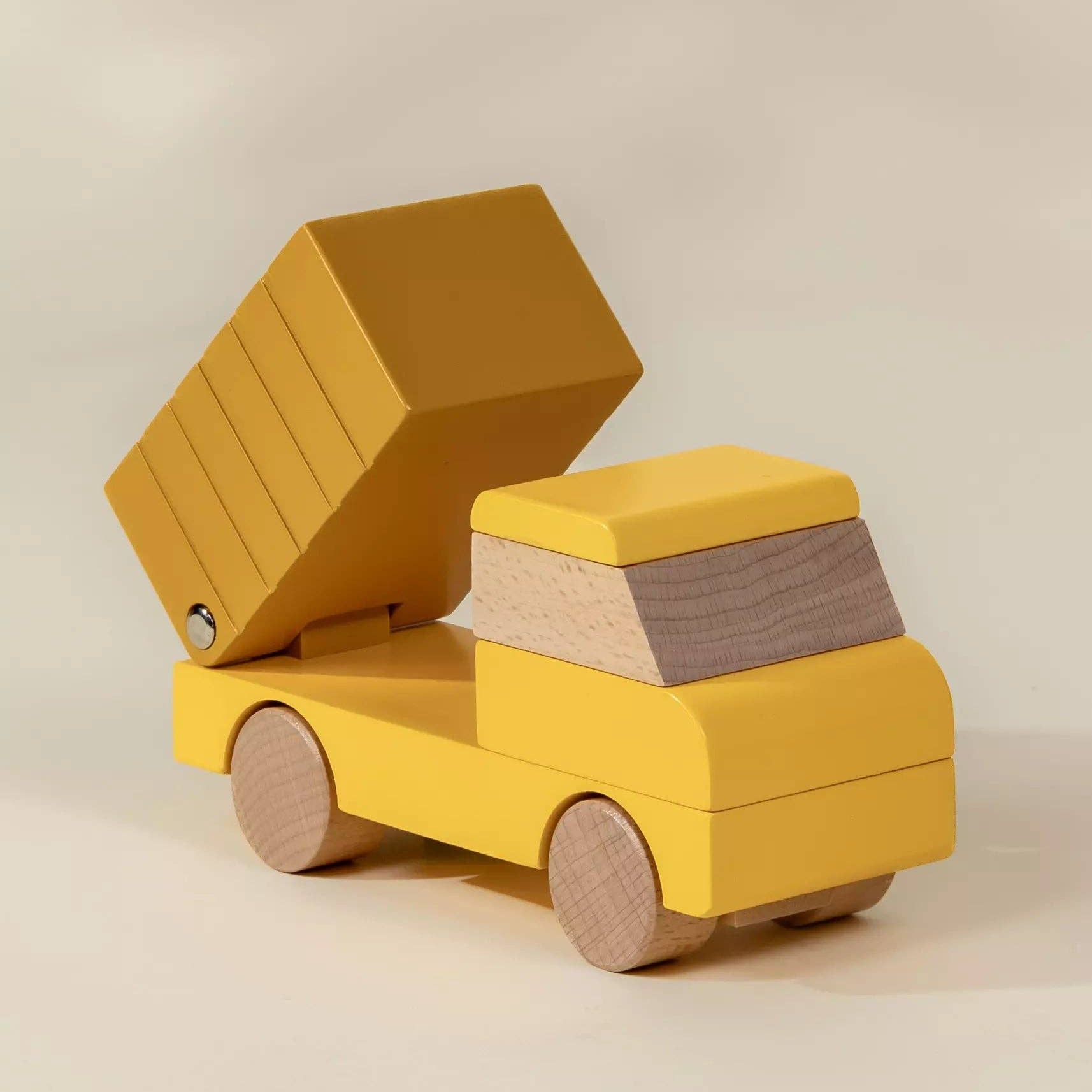 Yellow toy truck with an open cargo box on a beige background