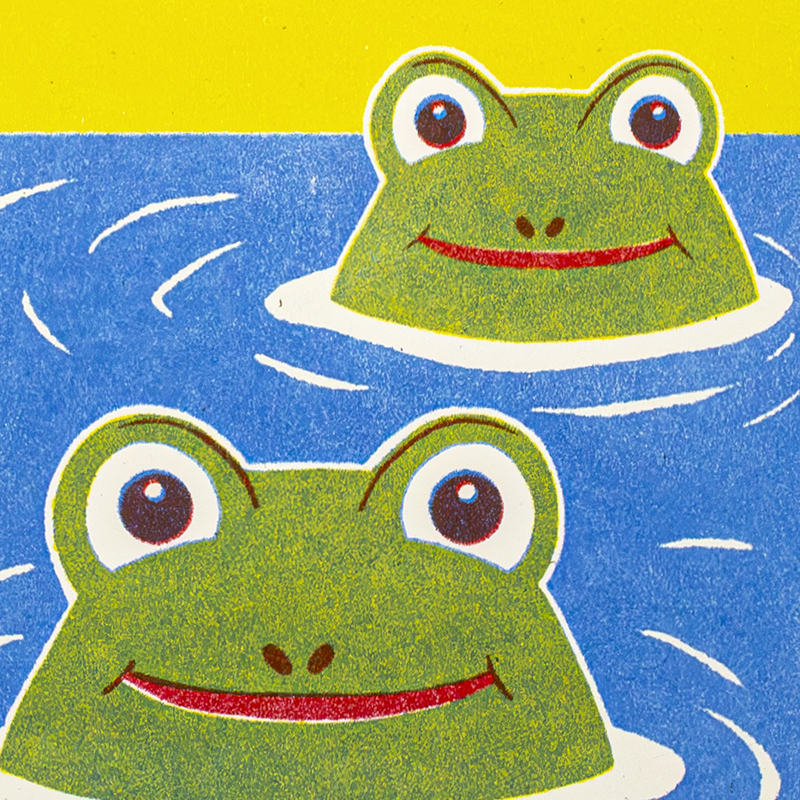 A colorful illustration of two green cartoon frogs with large eyes and red smiles floating in blue water, with a yellow background at the top.