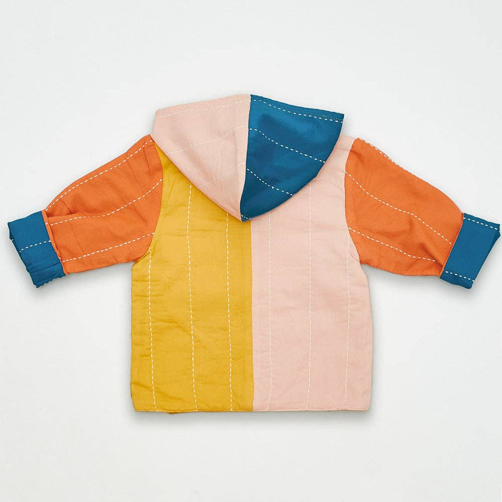 Color-blocked quilted jacket with orange, yellow, pink, and blue sections on a light gray background.
