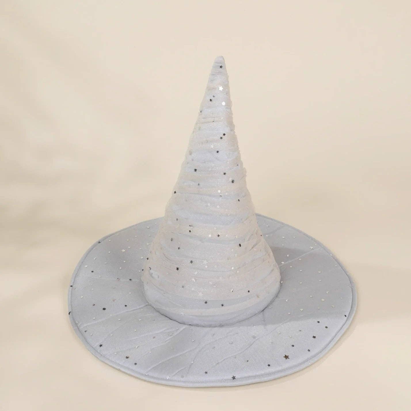 A light blue glittery witch hat cone decoration with a matching wide brim, photographed against a neutral cream background.