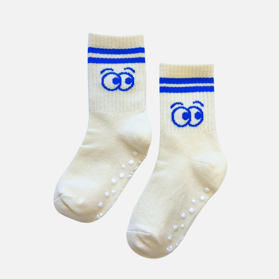 Pair of cream socks with blue accents and paw prints on a white background