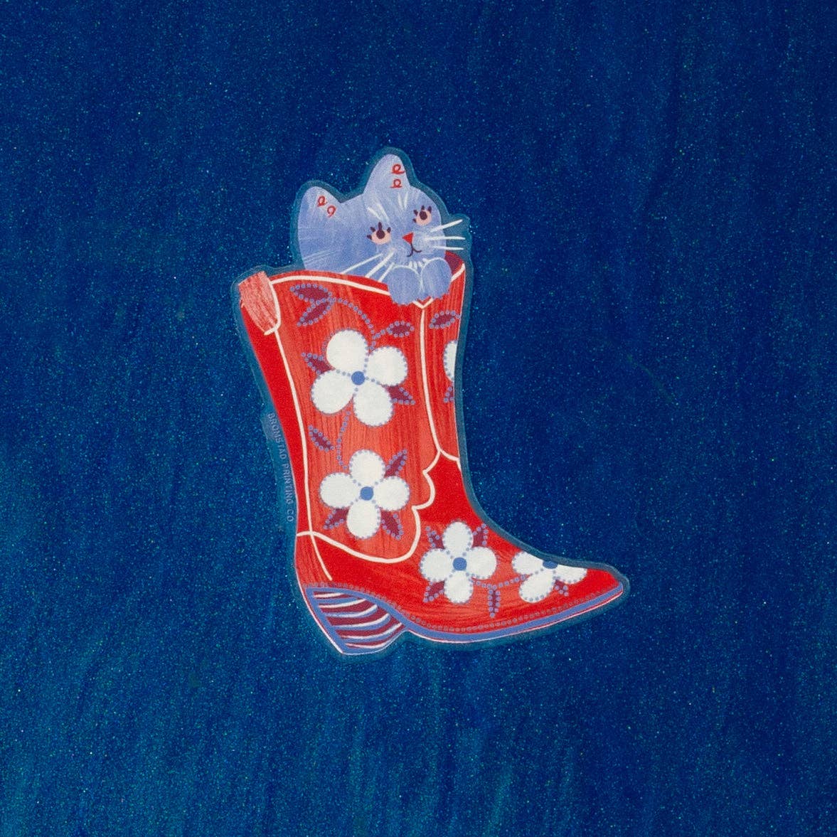 Red boot with white flowers and two cats on a blue background