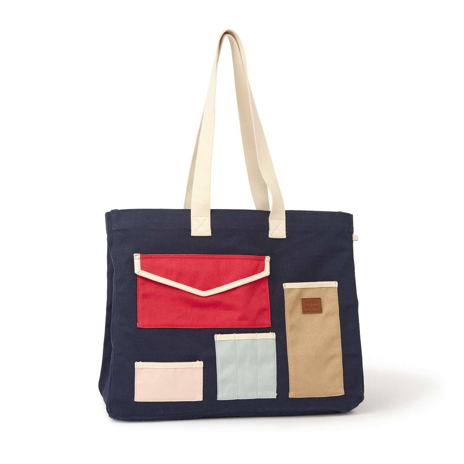 Navy tote bag with colorful pockets on a white background