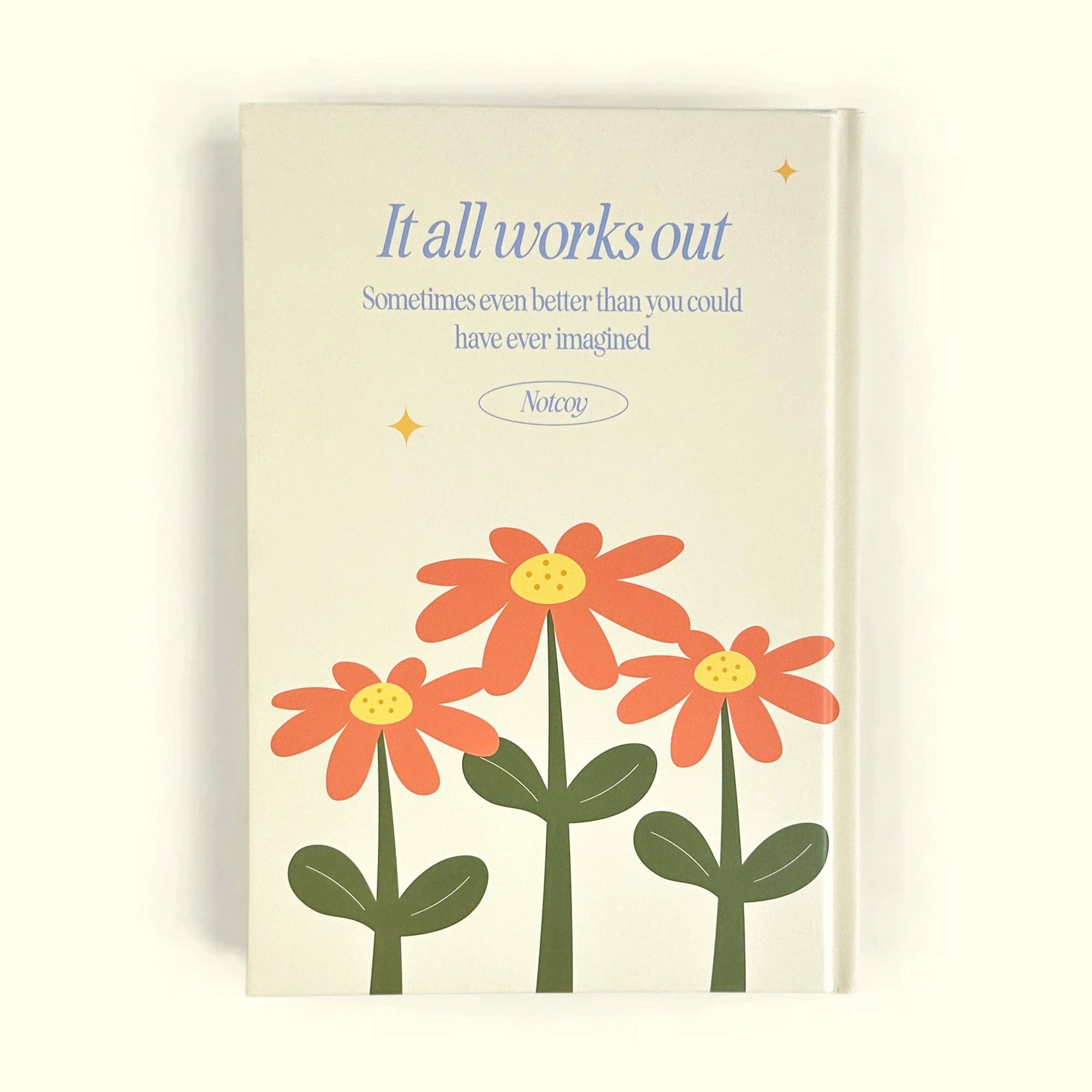 Book cover with flowers and motivational quote on a beige background