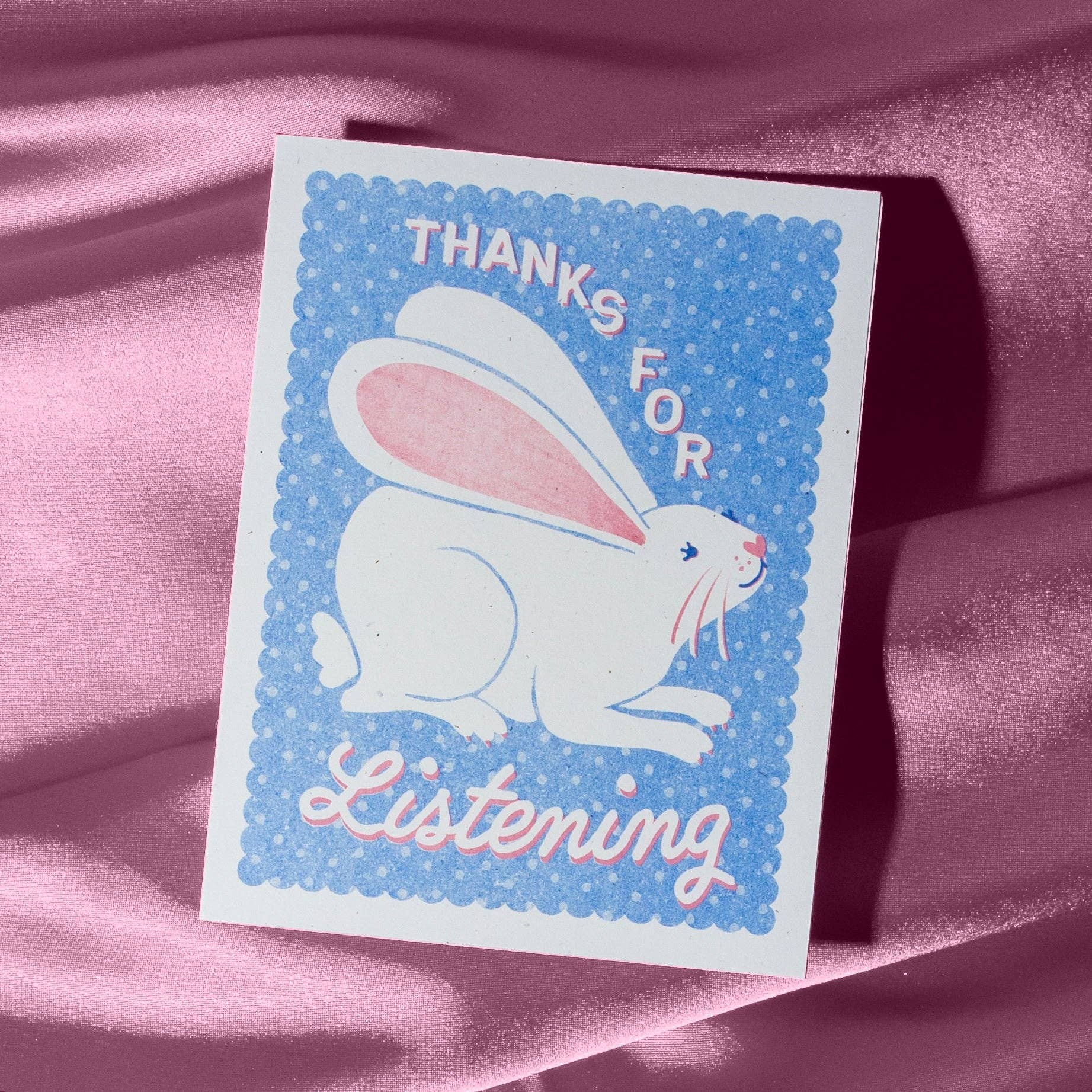 Card with a rabbit illustration and 'Thanks for Listening' text on a pink fabric background