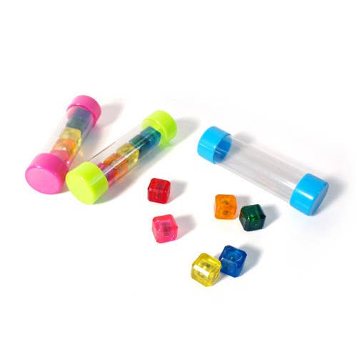 Colorful plastic dice and tubes on a white background