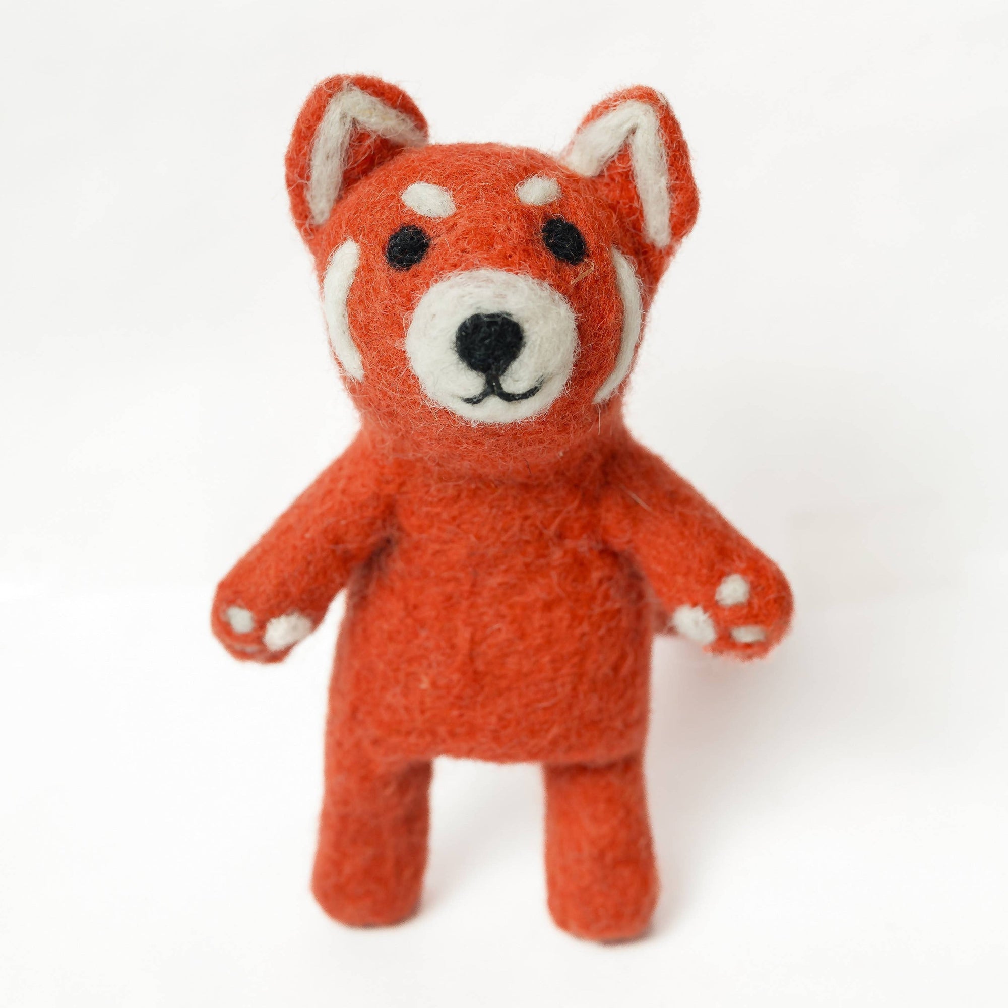 Small orange fox plush toy on a white background