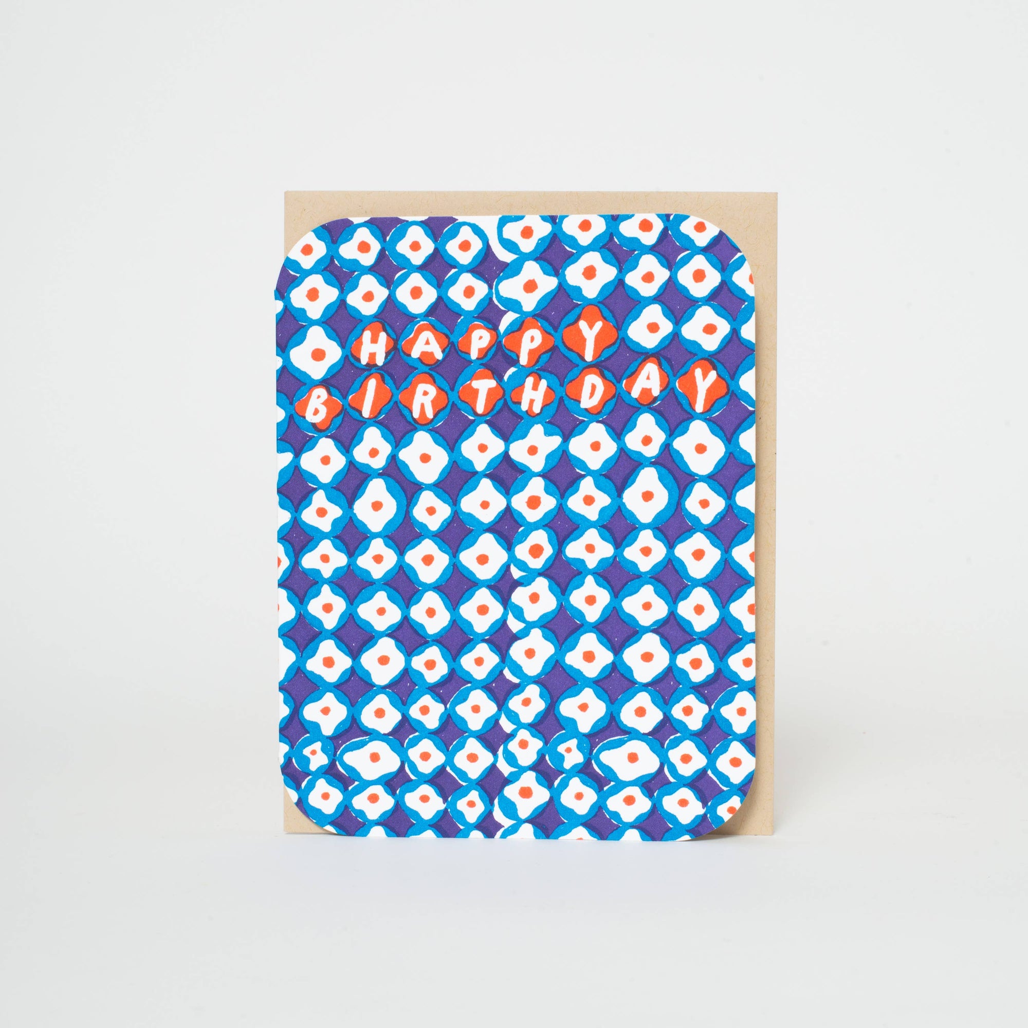Greeting card with blue and white pattern and 'Happy Birthday' text on a beige background