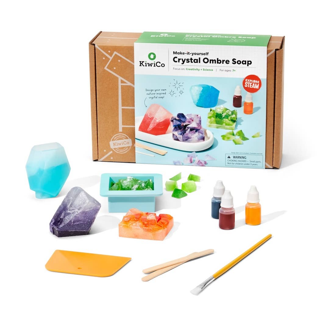 KiwiCo crystal ombre soap making kit with packaging, molds, and ingredients on a white background