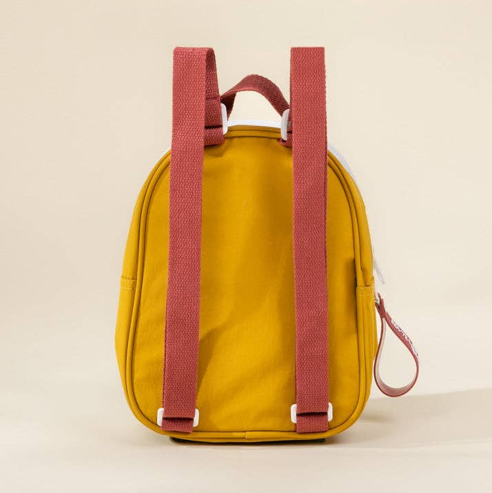 Yellow backpack with pink straps on a beige background