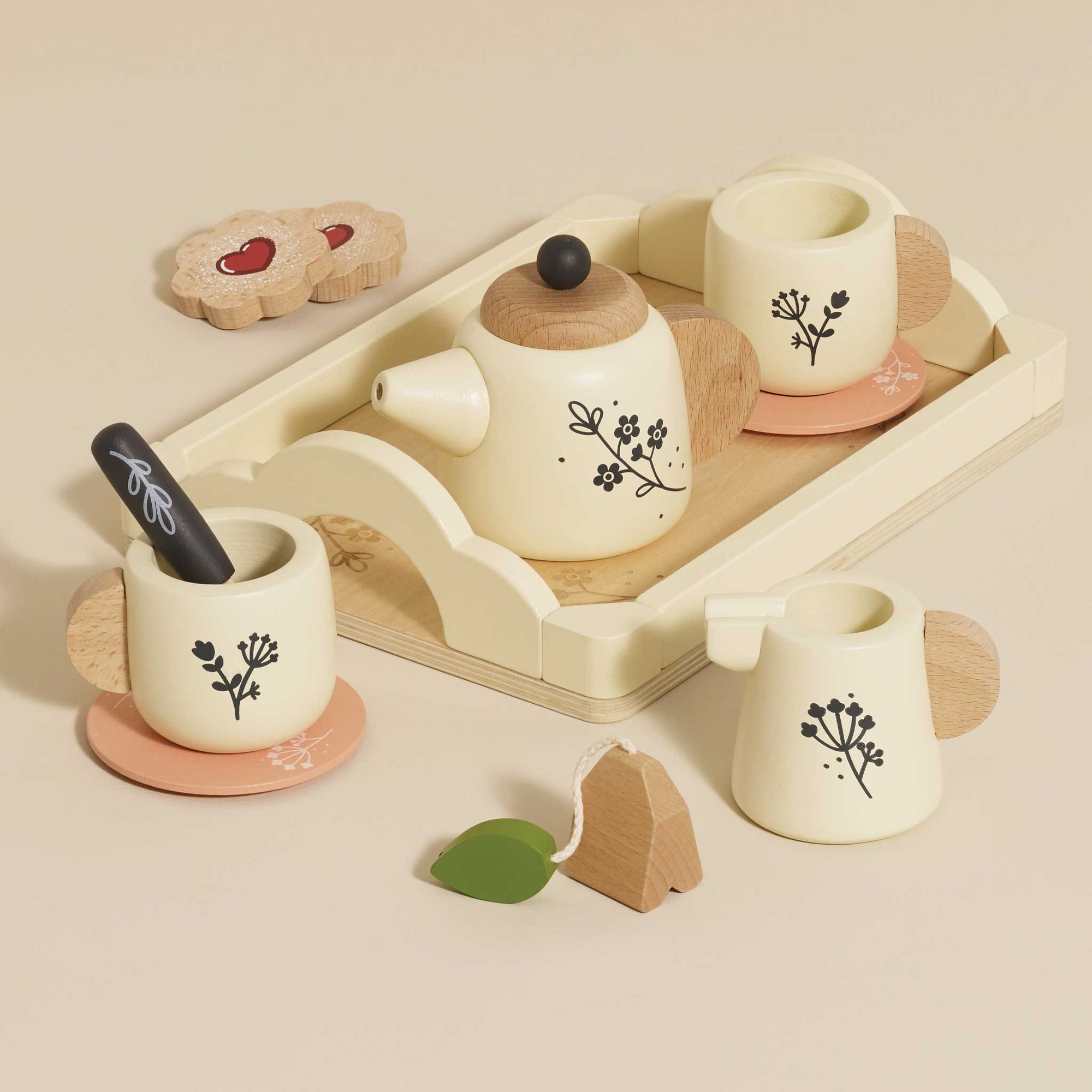Wooden tea set with ceramic teacups and saucers on a beige background