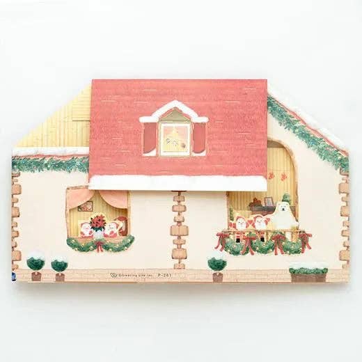 Small wooden house model with decorative elements on a white background