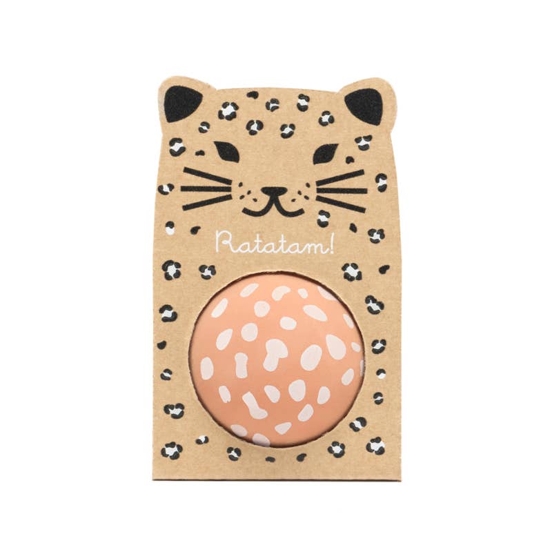Round pink object with white patterns in a leopard print box on a white background