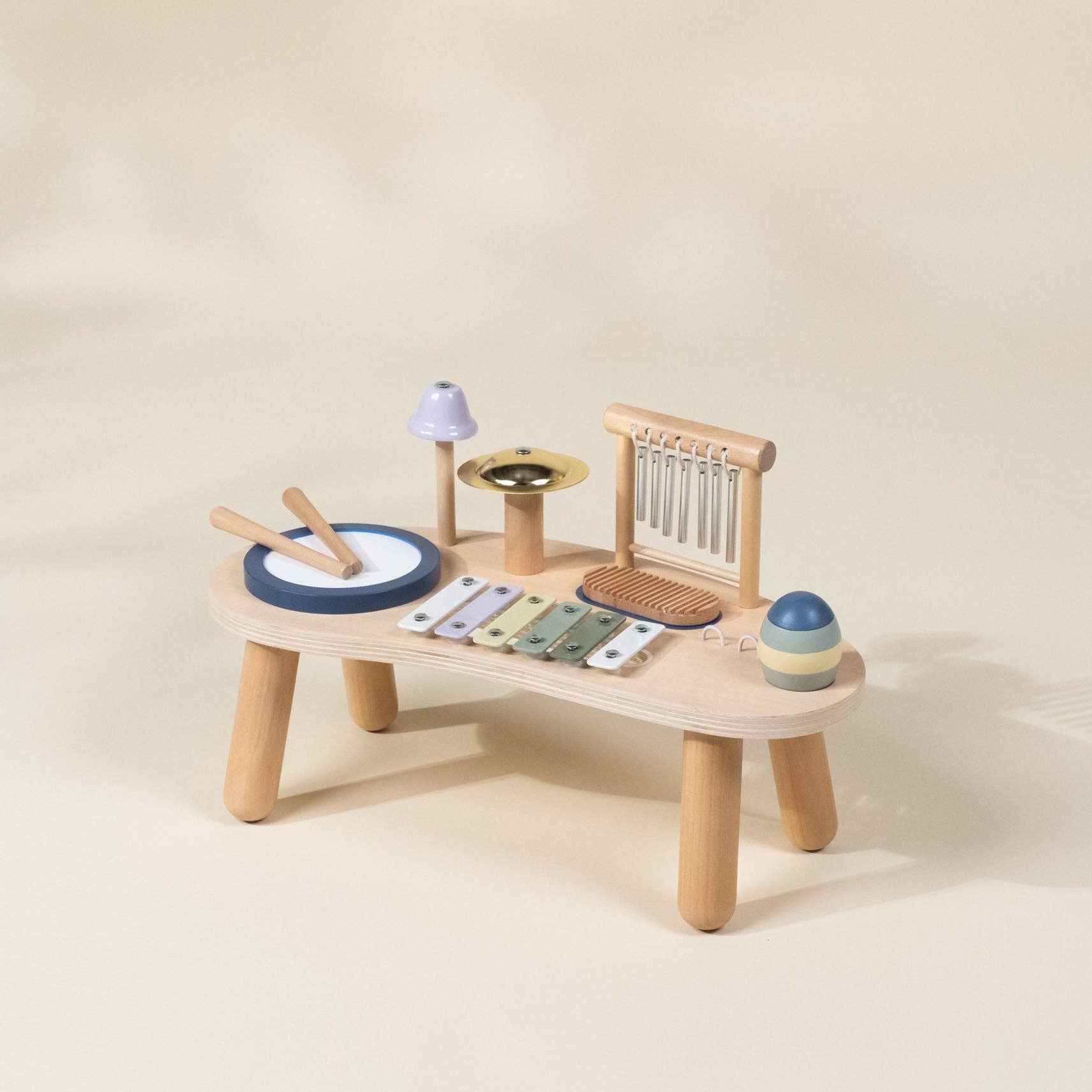 Wooden toy music set on a beige background