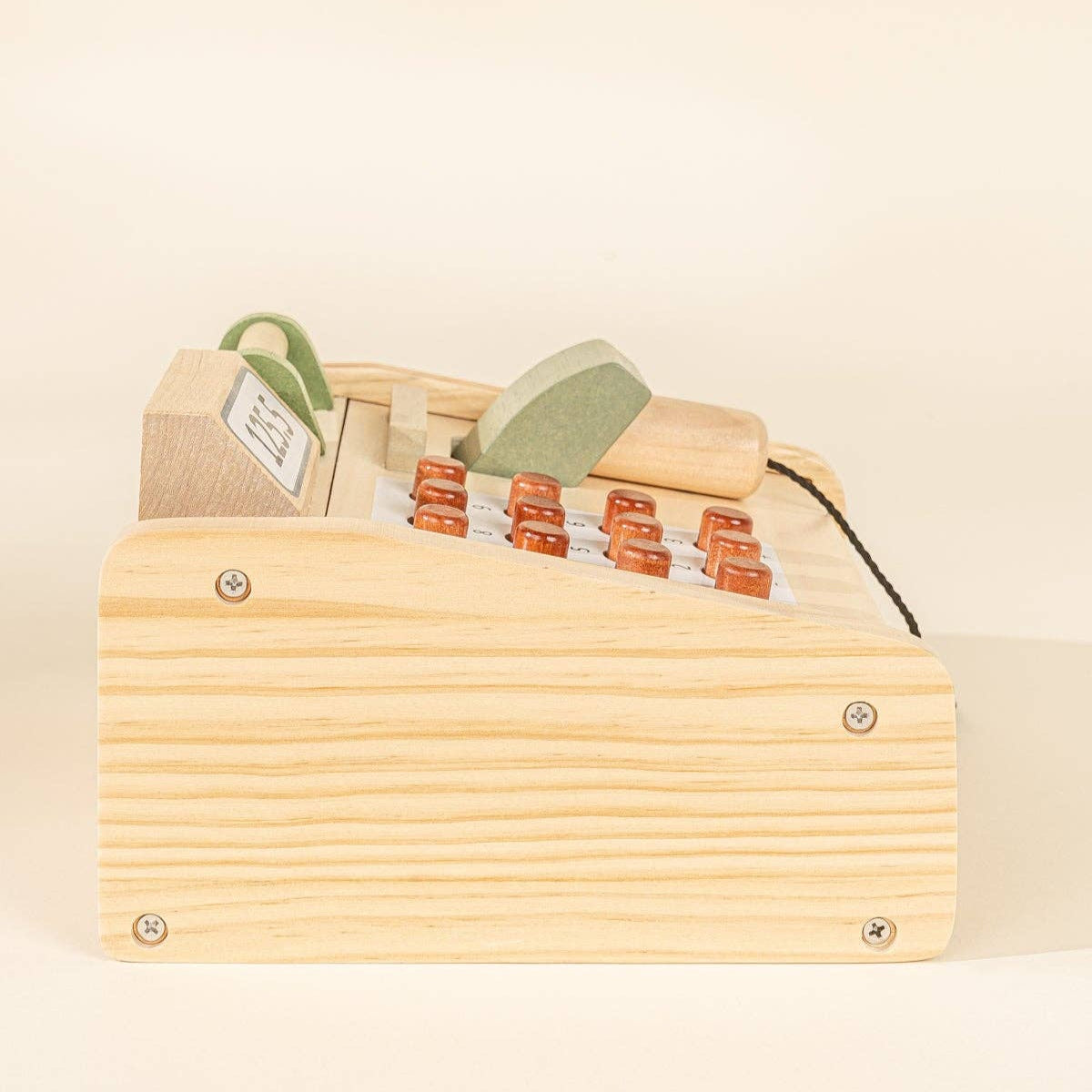 Wooden play register with buttons on a beige background