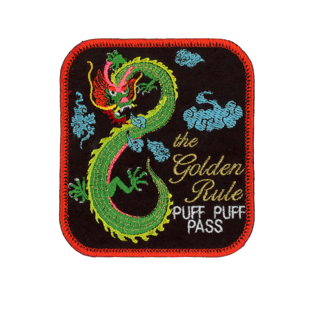 Embroidered patch with a green dragon design and text on a black background