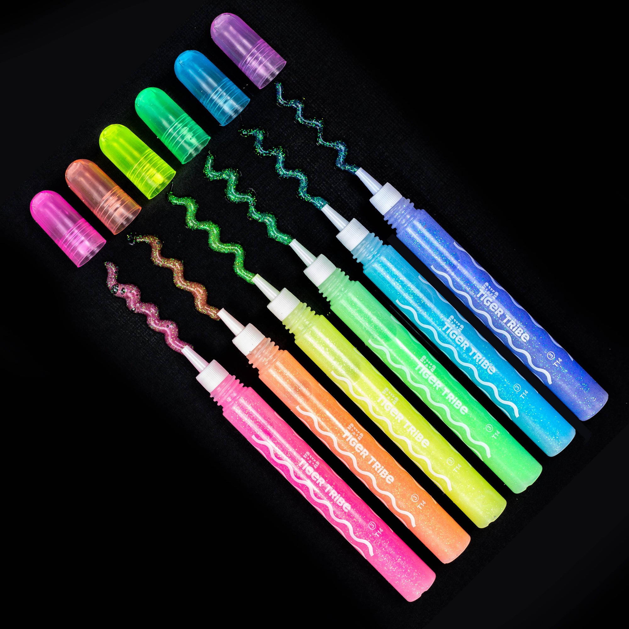 Set of colorful glow sticks with wavy patterns on a black background