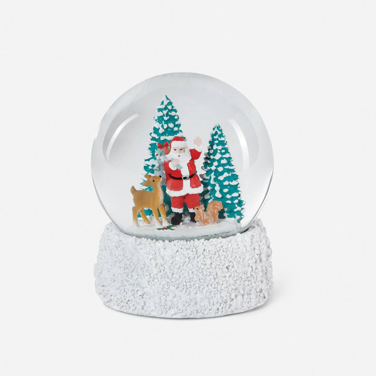 A small clear glass snow globe with a textured white base, featuring a festive holiday scene inside with Santa Claus, two green Christmas trees, and a brown reindeer, shown on a plain white background.