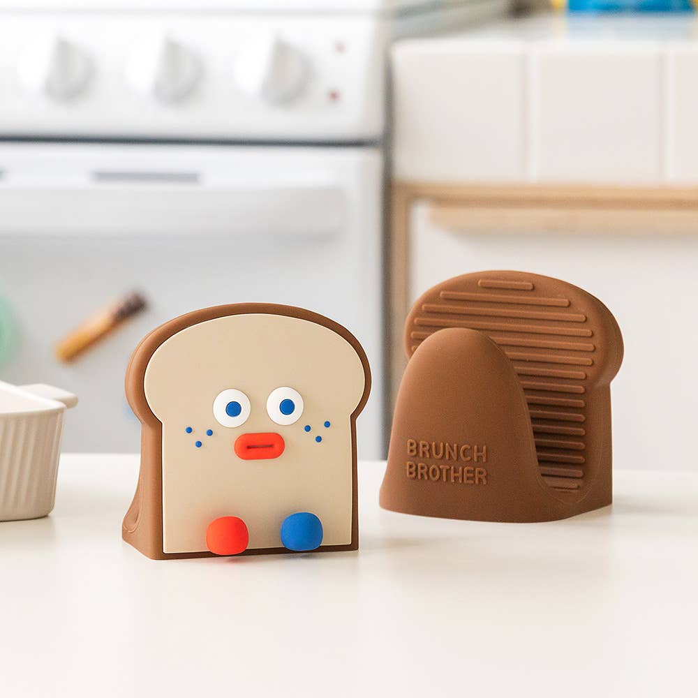 Two silicone bread-shaped molds with a face design on a kitchen counter.