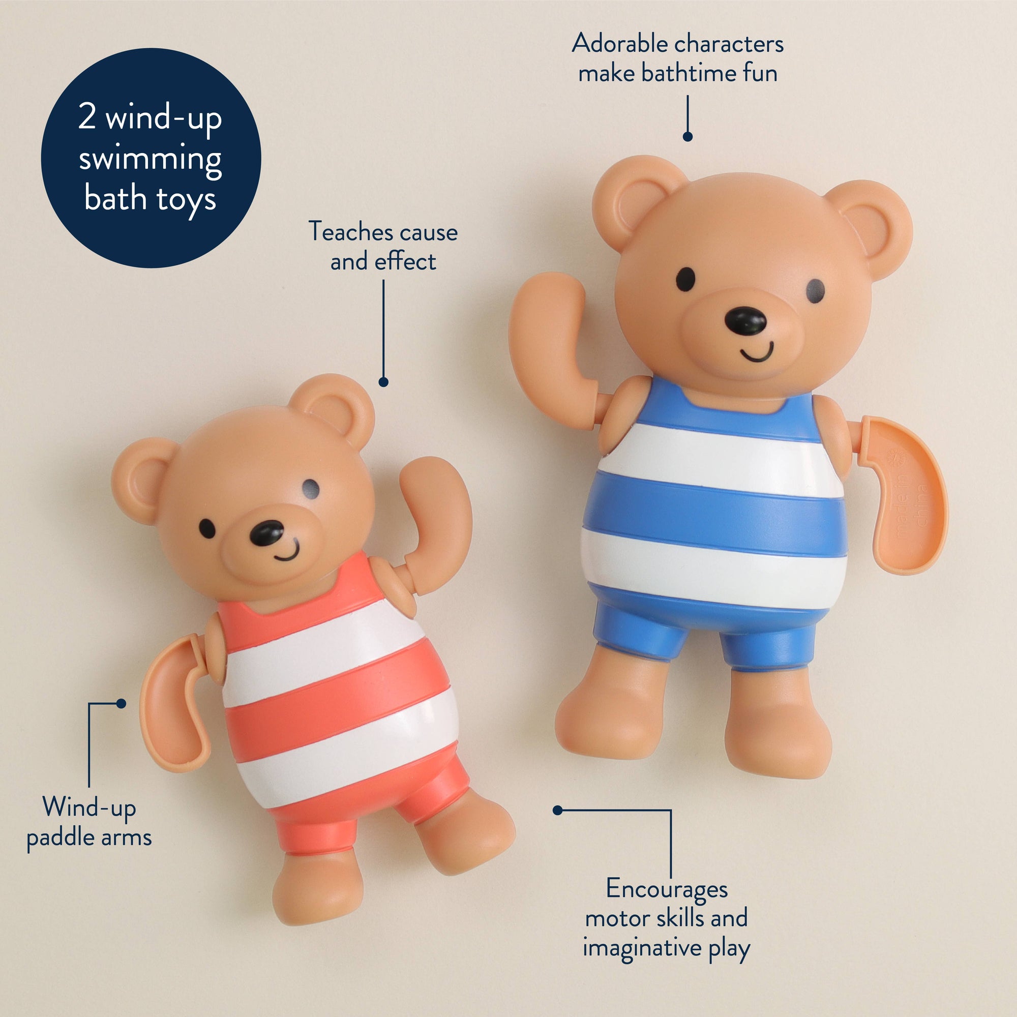 Two wind-up swimming bath toys with labels on a beige background