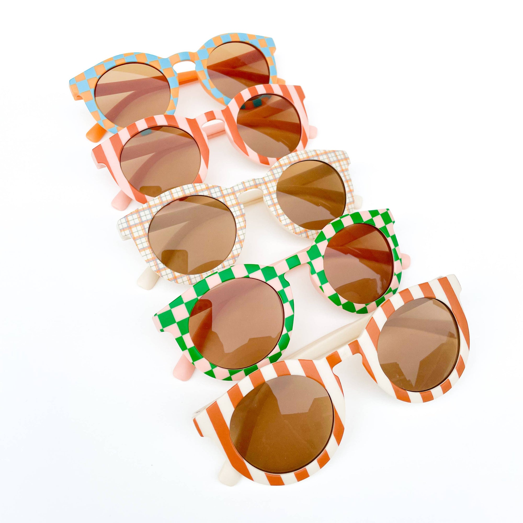Stack of colorful sunglasses with decorative frames on a white background