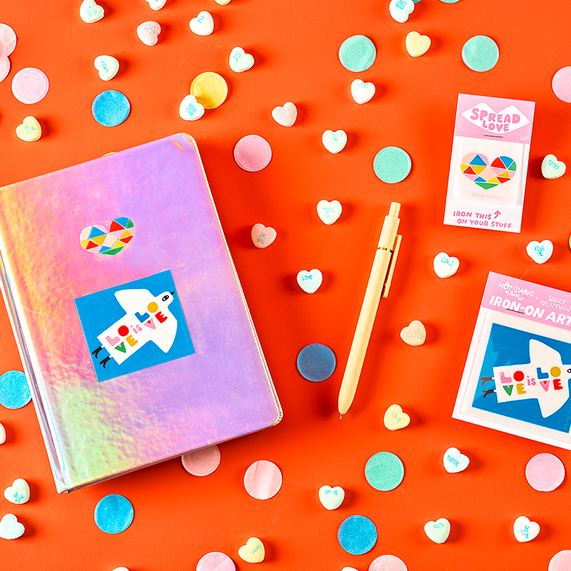 Colorful stationery items on a bright orange background with confetti