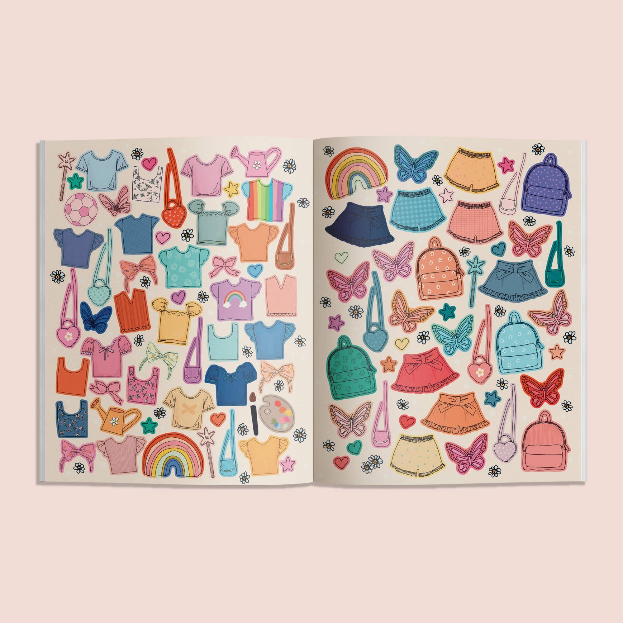 Open book with colorful clothing and accessory illustrations on a light pink background