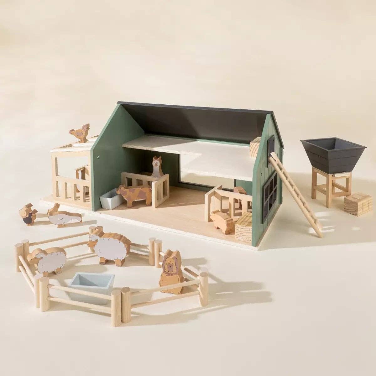 Wooden toy farm set on a beige background