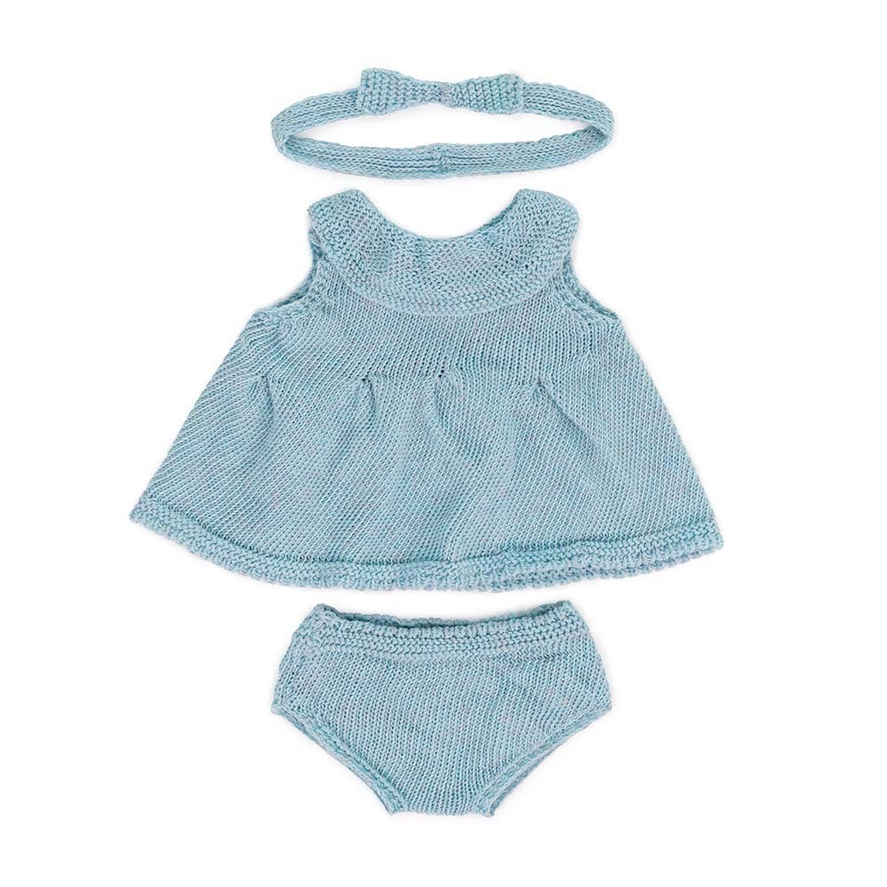 Light blue knitted doll outfit with top, shorts, and headband on a white background