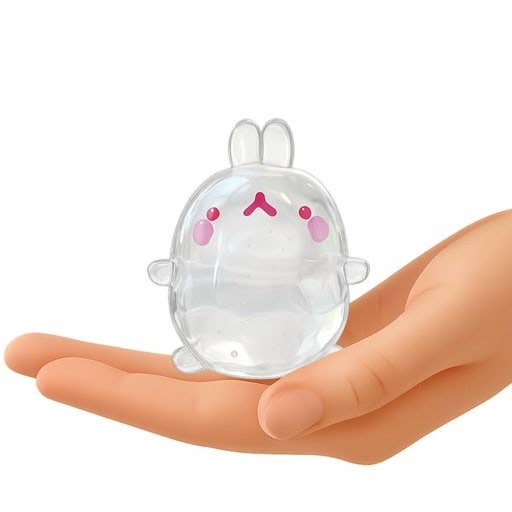 Clear plastic bunny-shaped object held in a hand on a white background