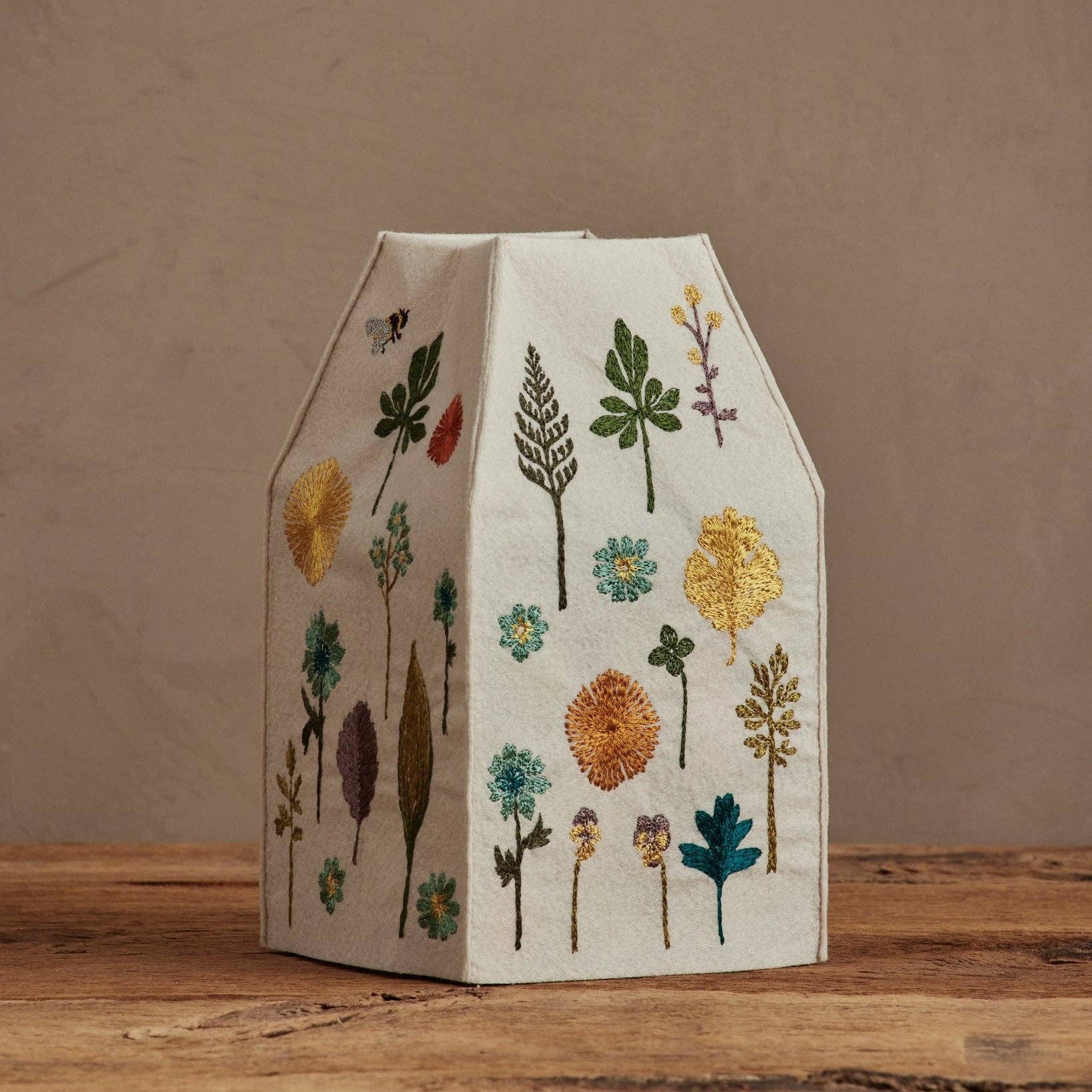 Decorative box with floral patterns on a wooden surface and brown background