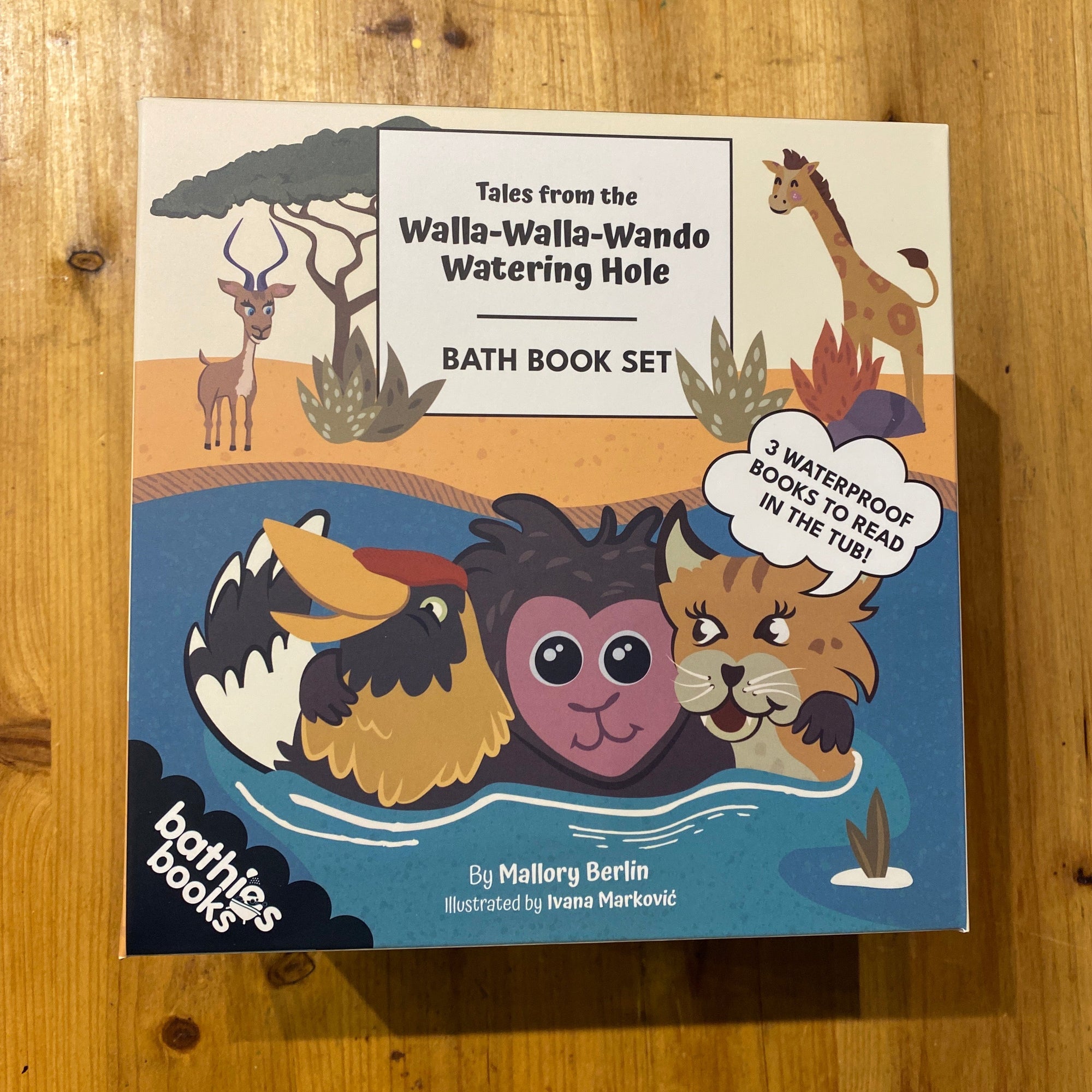 Bath book set with animal illustrations on a wooden surface