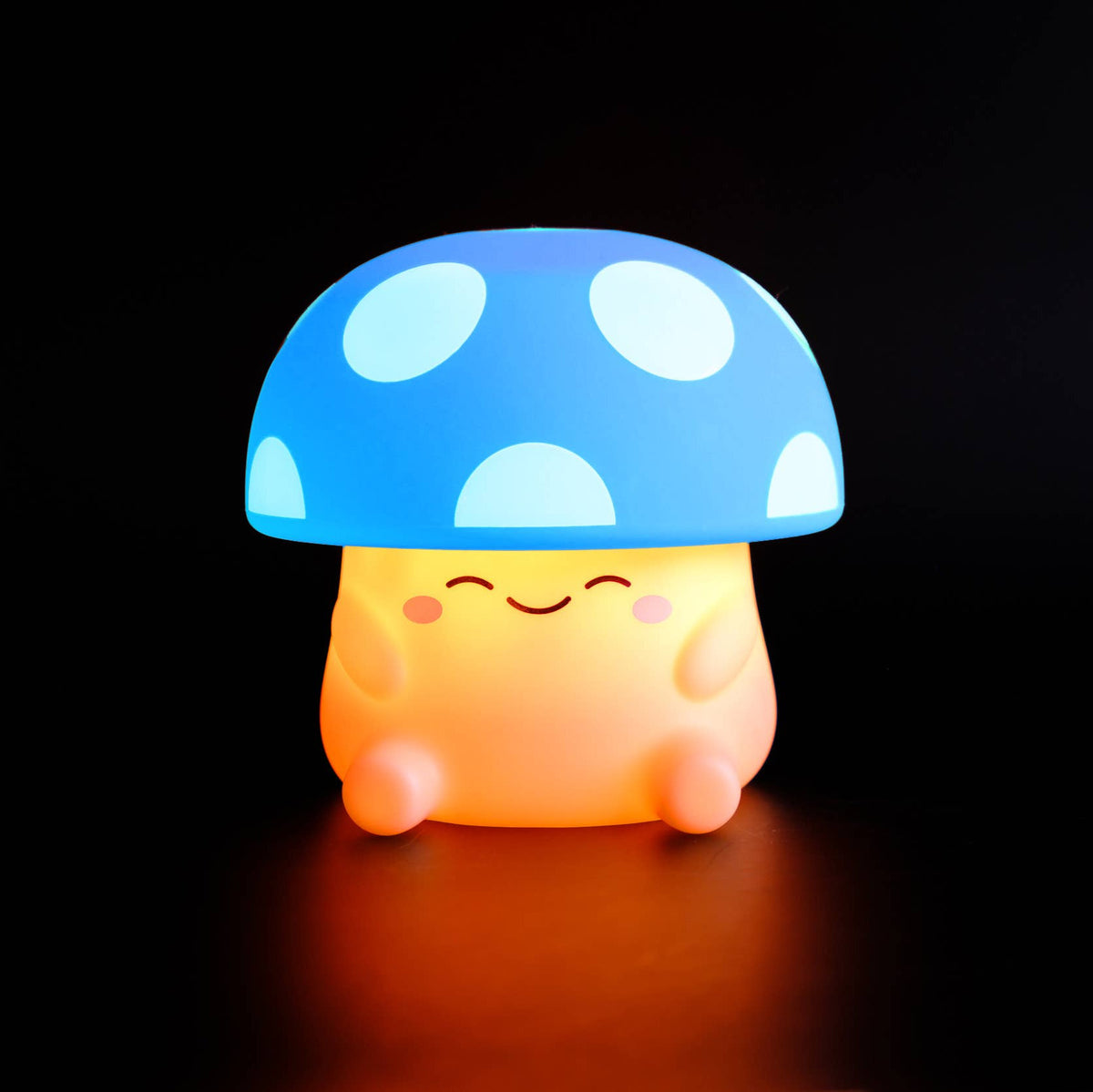 Mushroom-shaped night light with blue cap and orange body on a black background