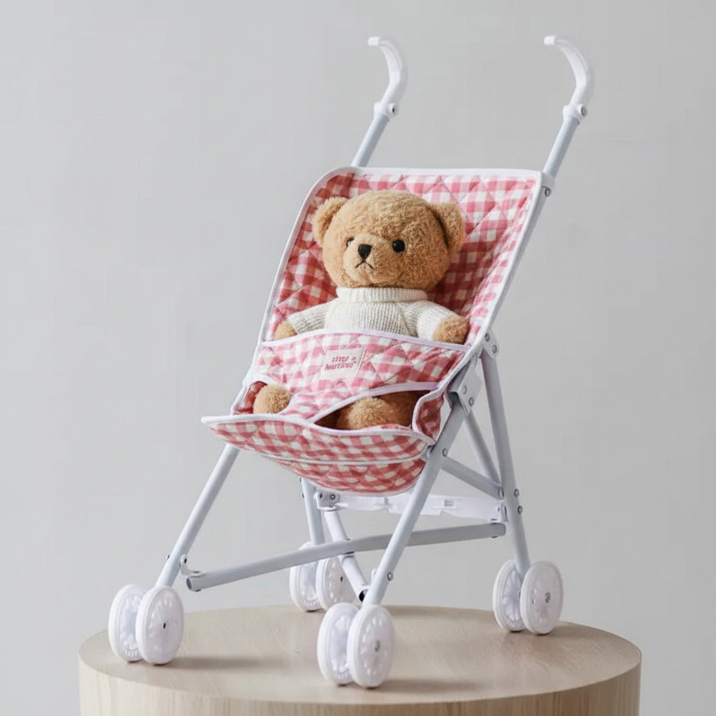 Small baby stroller with red and white checkered canopy on a light gray background
