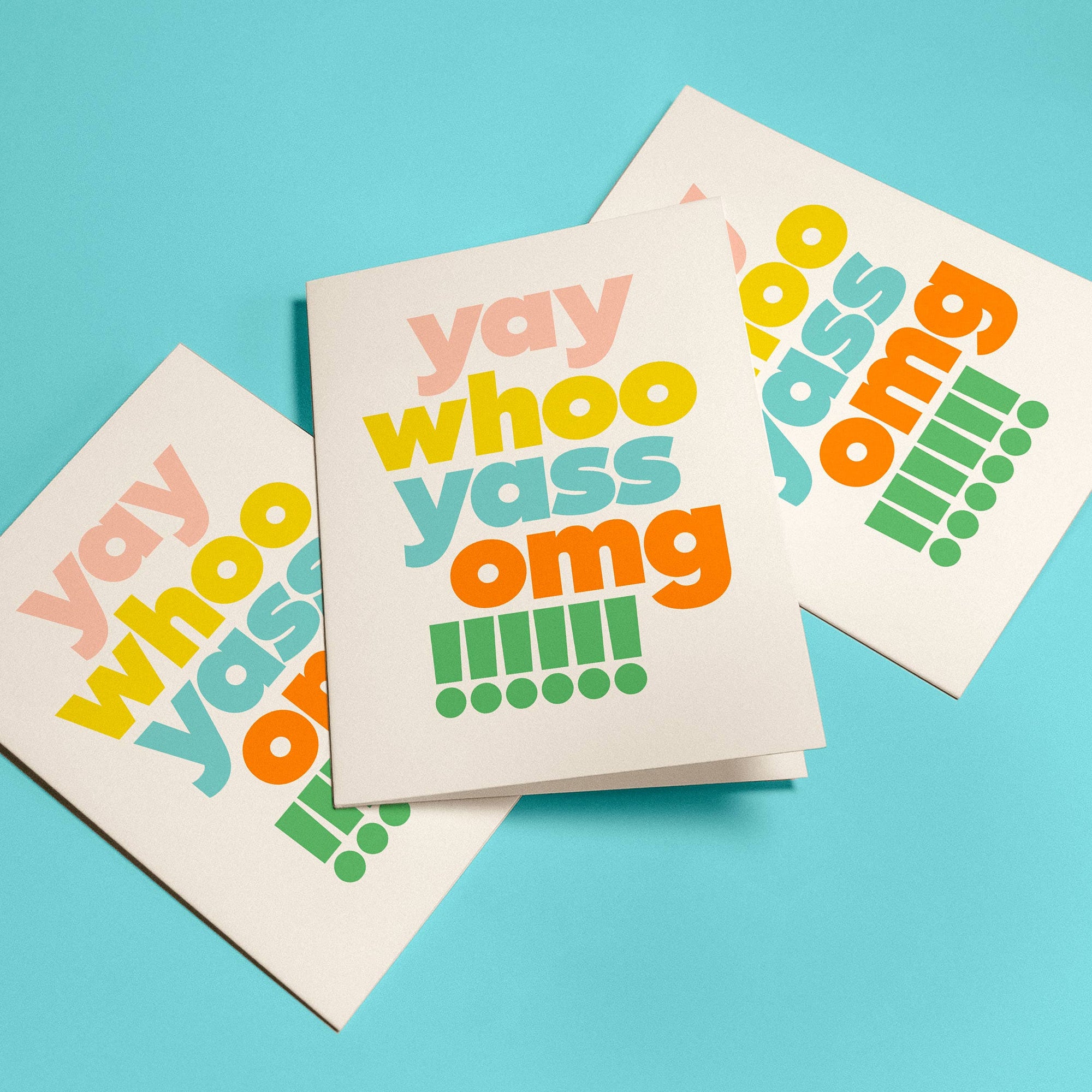 Three greeting cards with colorful text on a blue background