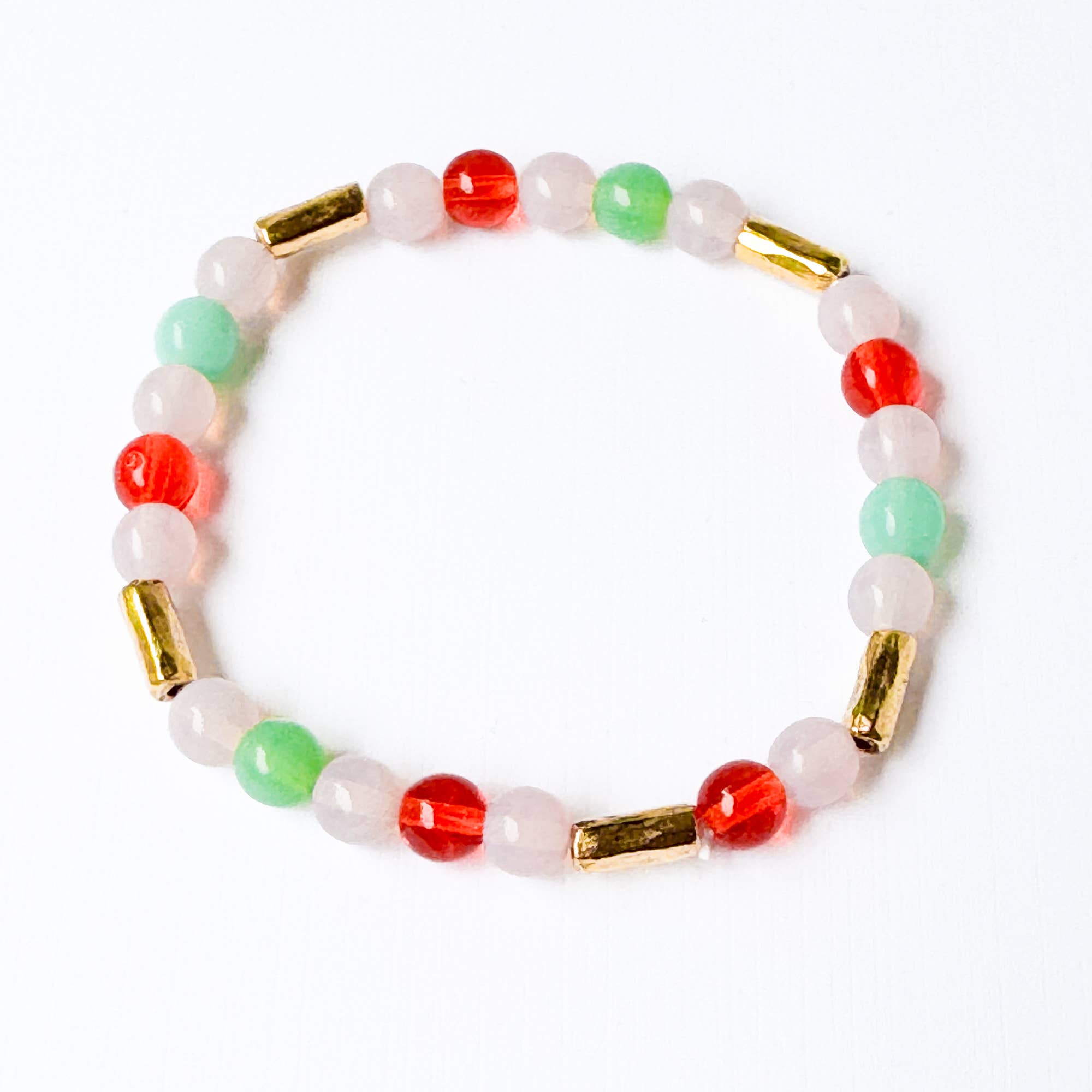 Beaded bracelet with red, green, and gold accents on a white background