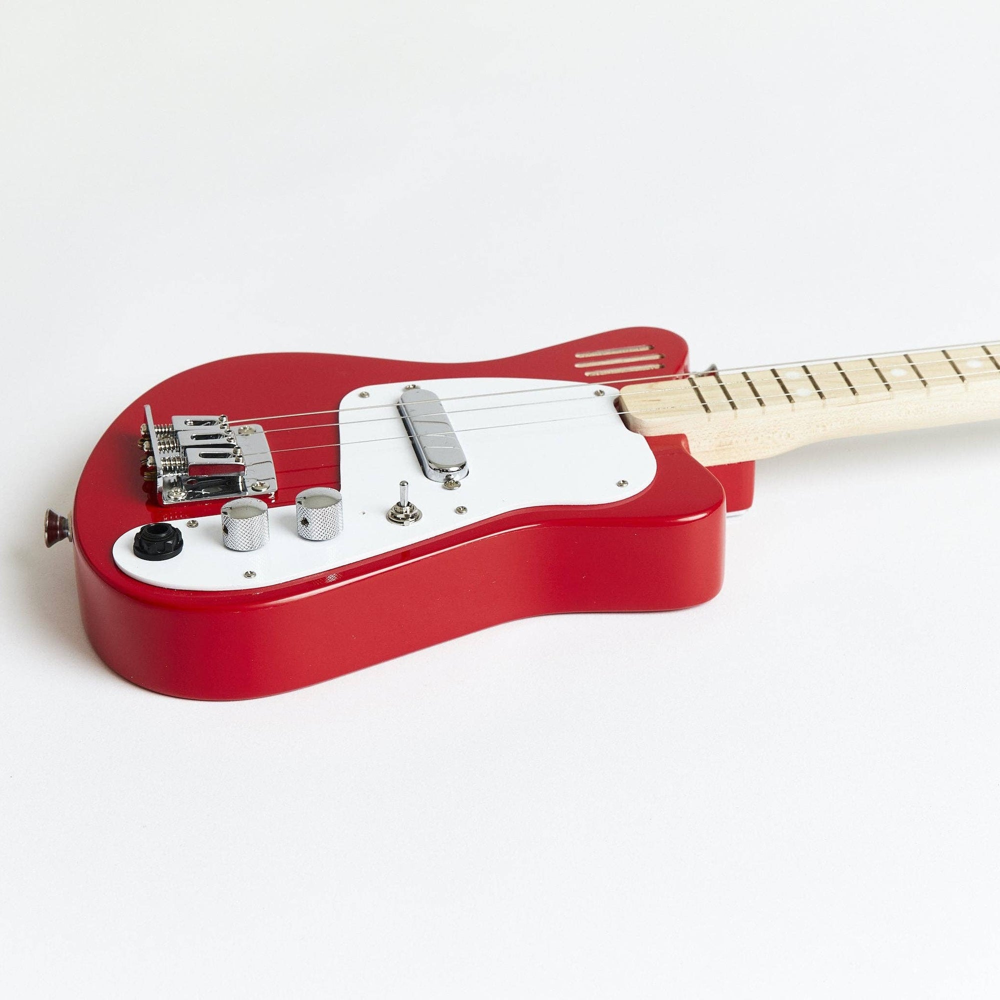 Red electric guitar on a white background