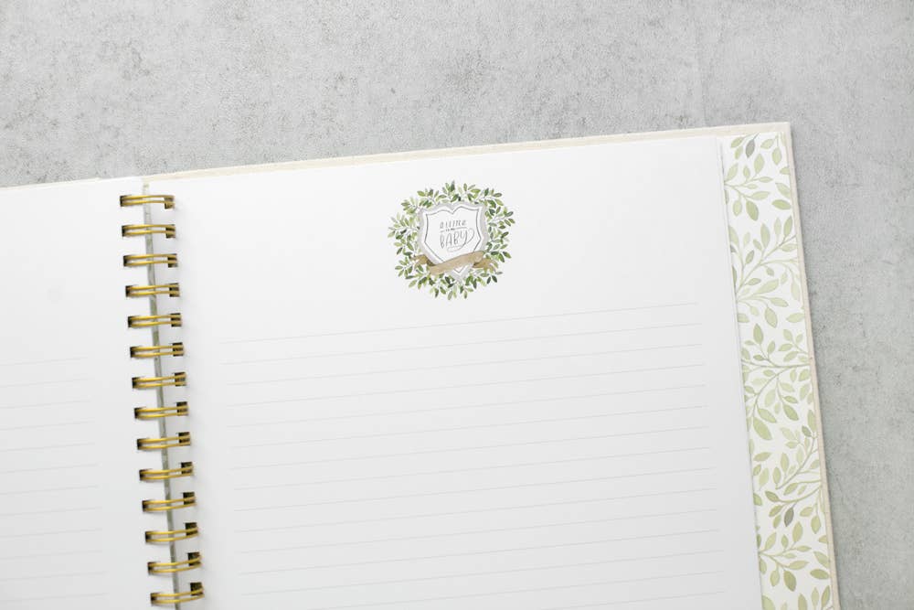 Open planner with floral design on a gray surface