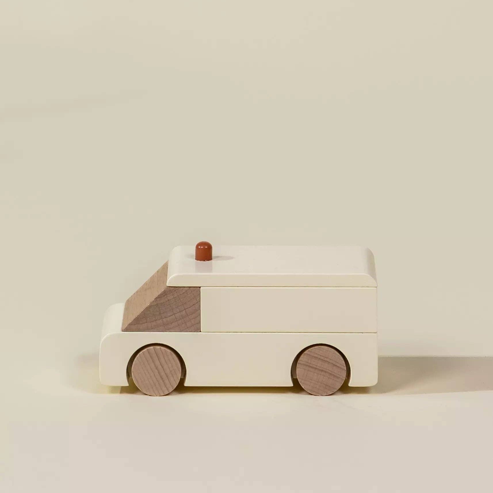 Wooden toy van on a beige background
