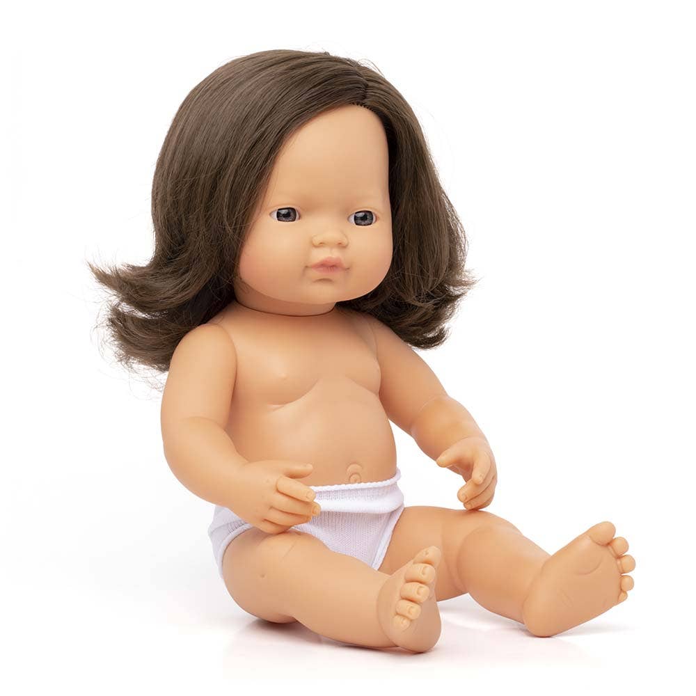 Baby doll with brown hair wearing a white diaper on a white background